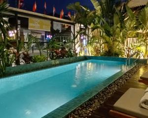 a swimming pool in a resort at night at Baahu Villa in Siem Reap
