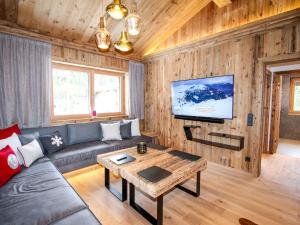 a living room with a couch and a table at Luxury chalet Pinzgauer Almhütte in Königsleiten in Königsleiten