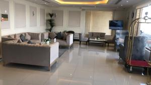 a living room with couches and a flat screen tv at فيولا للشقق المخدومة in Riyadh