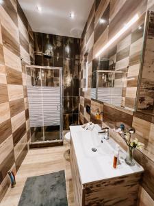 a bathroom with a sink and a shower at Galini Studios Paralia Platanou in Akrata