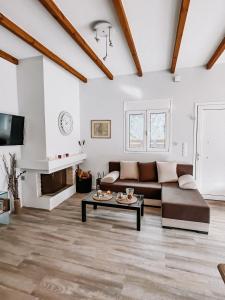 a living room with a couch and a table at Galini Studios Paralia Platanou in Akrata