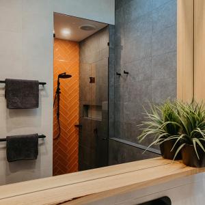 a shower with a glass door in a bathroom at Mt Martha Retreat in Mount Martha