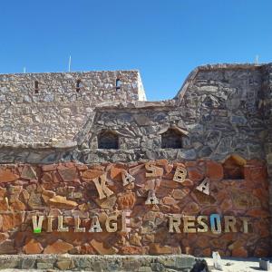 a stone building with a sign on the side of it at Sariska Kasba A Village Resort in Tehla