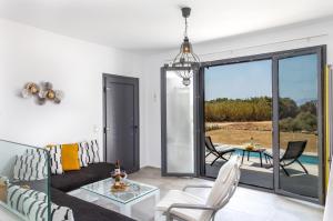 a living room with a couch and a table at Bamboo Villa Naxos in Mikri Vigla