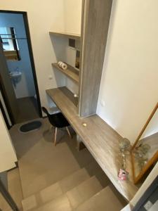 a room with a wooden desk with a mirror at Mely’s Tiny Home in Samporo