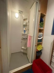 a walk in closet with a glass door at spaceMU in Osaka