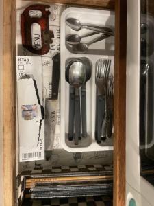 a drawer filled with utensils in a cabinet at spaceMU in Osaka