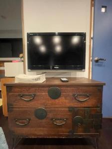 a television on top of a dresser with a drawer at spaceMU in Osaka