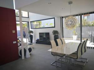 een woonkamer met een tafel en stoelen en een open haard bij Precioso chalet vanguardista in Palma de Mallorca