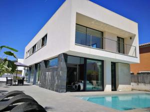 a white house with a swimming pool in front of it at Precioso chalet vanguardista in Palma de Mallorca
