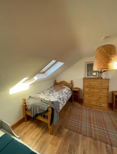 a bedroom with a bed and a skylight at Modern self catering apartment, Miltown Malbay in Milltown Malbay