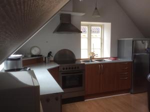 a kitchen with a sink and a stove top oven at Postholderens sted in Guldborg