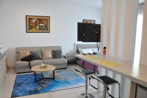 a kitchen and living room with a table and a couch at Bayu Bangi in Bangi