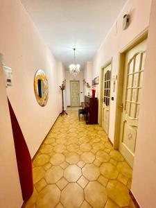 a hallway with a yellow tile floor in a building at Feels like home in Turin