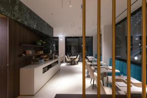 イェージにあるHotel Dei Naniのテーブルと椅子のあるレストラン、プールを提供しています。
