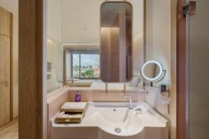 a bathroom with a sink and a mirror at Centara Ubon in Ubon Ratchathani