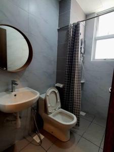 a bathroom with a sink and a toilet and a mirror at Cozy Spacious Home 2 BR SKS Habitat Larkin JB in Johor Bahru