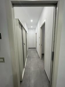 an empty hallway with doors and a tile floor at La Casa Di Lilla in Tortoreto Lido