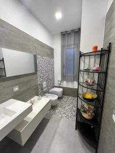 a bathroom with a sink and a toilet at La Casa Di Lilla in Tortoreto Lido