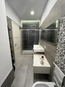 a bathroom with two sinks and a shower at La Casa Di Lilla in Tortoreto Lido