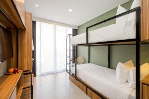 a bedroom with bunk beds in a room at Rimbun Canggu Hotel in Canggu