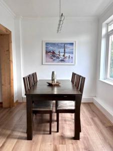 a dining room with a table and two chairs at Spacious 3 bedroom centrally located house in Jesmond