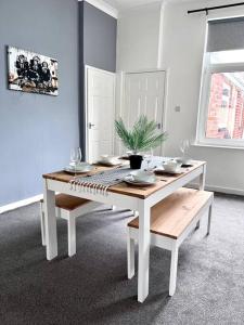 a dining room table with a potted plant on it at Great location, spacious 3 bedroom house in Pallion