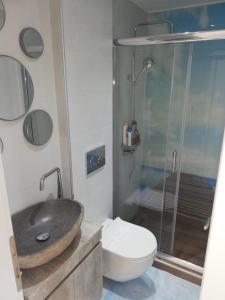 a bathroom with a sink and a toilet and a shower at W Apartment in Chania Town