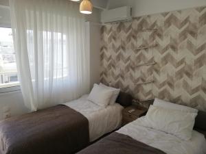 Un pat sau paturi într-o cameră la W Apartment