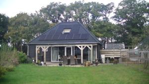 a house with solar panels on top of it at Lombok in Westerbork