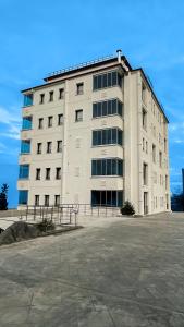 a large white building with a lot of windows at Caykent Suites Deluxe Hotel in Trabzon