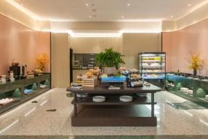 a store with a buffet of food on a table at SSAW Boutique Hotel Zhijiang in Hangzhou