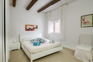 Loceri的住宿－Casa Vacanza Il Murales，白色的卧室设有床和窗户