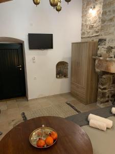 a room with a table with a bowl of fruit on it at Sterna in Mesovounion-Zagori