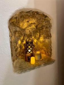 a painting of a wall with two candles on a shelf at Sterna in Mesovounion-Zagori