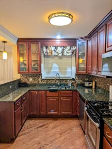 a kitchen with wooden cabinets and a sink at Chicago Home 6 bd 4 ba home with 2 car garage parking in Chicago