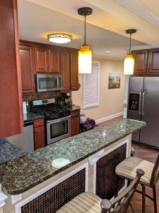 a kitchen with wooden cabinets and a granite counter top at Chicago Home 6 bd 4 ba home with 2 car garage parking in Chicago