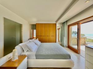 a bedroom with a large bed and a large window at Luxury Villa in Sani, Halkidiki, Greece in Sani Beach +25 photos