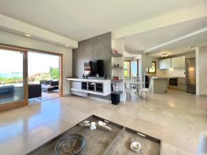 a large living room with a table and a kitchen at Luxury Villa in Sani, Halkidiki, Greece in Sani Beach