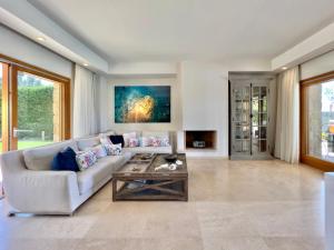 a living room with a couch and a table at Luxury Villa in Sani, Halkidiki, Greece in Sani Beach