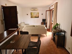 a living room with a table and a couch at Apartamentos Osa Menor in Cala d´Or