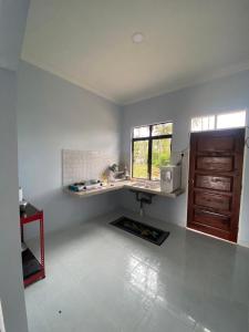 a kitchen with a counter and a sink in a room at Tok Mek Homestay in Setiu