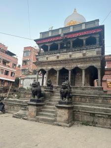 a building with some statues in front of it at Newa service apartment in Pātan