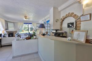 a kitchen with a counter and a living room at Hotel Cayrons Vence & St Paul de Vence in Vence