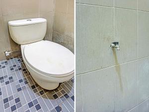 a bathroom with a toilet in a tiled room at OYO Life 92091 Citra Omah Syariah in Blimbing
