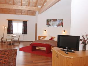 a bedroom with a bed and a flat screen tv at Hotel Goldene Rose in Reutte