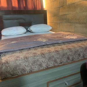 a bed with two pillows on top of it at HPLagos in Lagos