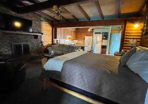 a bedroom with a large bed and a living room at Olde Mill Inn of Clarkston in Clarkston