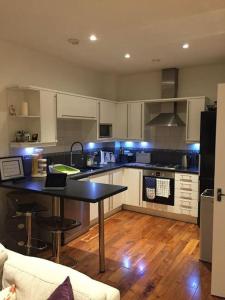 a kitchen with a table and a counter top at Sea View Penthouse Marina Apartment in Portishead