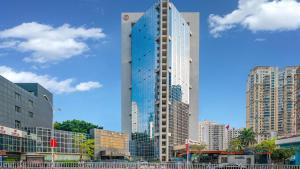 a tall building in the middle of a city at Binbei Yiho Hotel in Xiamen